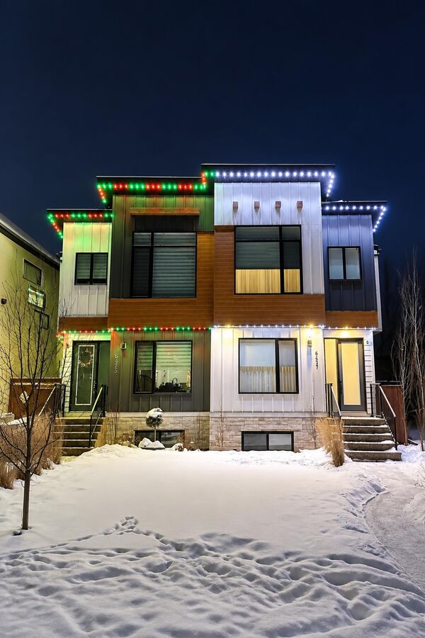 Permanent LED lighting in warm and cool tones on a Calgary home at night