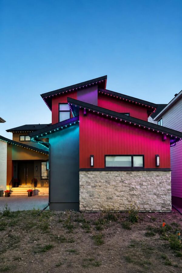 Permanent LED lighting in red and pink tones on a modern Calgary home